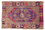 Vintage Distressed Oushak rug, plum hexagonal medallion, colorful floral border, softened pile.