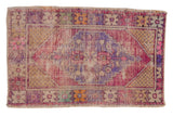 Distressed Oushak rug, hand knotted, featuring faded purple, magenta, and saffron medallion design.