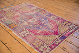 Distressed Oushak rug corner showcasing saffron yellow staggered seed motif and visible pile wear.