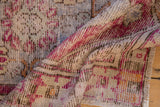 Decorative distressed Oushak rug pile with plum, saffron, and ivory tones.