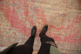 Distressed Oushak carpet with worn pile, faded pink, ivory, and seafoam green traditional pattern.