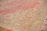 Distressed vintage Oushak border showing aged pink, ivory, seafoam green vinery, abrashed ground.