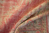 Distressed Oushak carpet pile showing mostly even wear in faded pink, ivory, and seafoam green.