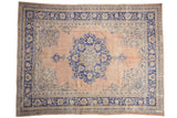 Vintage Distressed Oushak carpet with a peach field and bold cobalt blue medallion and spandrels.