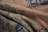 Distressed pile texture and rich cobalt blue patterns of a vintage Oushak rug.