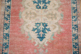 Distressed blush field with navy palmette design on a vintage Oushak rug runner.