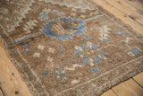 Distressed texture of vintage Oushak rug with denim blue serrated motif.