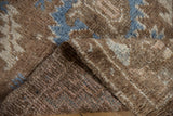 Distressed pile texture and hand-knotted foundation of a vintage Oushak rug.