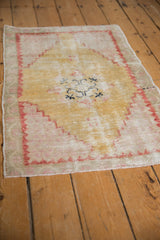 Distressed vintage Oushak rug corner with pale brick red stepped spandrel.