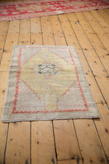 Distressed Oushak rug worn texture, dusty gold, pale brick red stepped border.