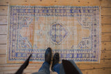 Distressed Oushak corner, even wear to knot heads, abrash field, blue and ivory border.