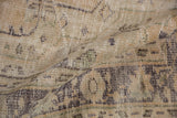 Distressed Oushak carpet, folded, showing mostly even wear to knot heads.