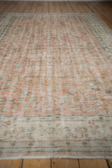 Distressed Oushak rug end, faded pale terracotta, ivory, mint vinery pattern, short fringe.