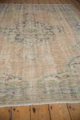 Distressed vintage Oushak rug edge, low pile with foundation, faded blue floral border.