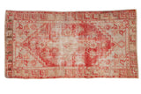 Distressed Oushak runner with faded red medallion, floral designs on beige field, 2'7