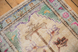 Vintage Oushak rug with distressed ivory ground, tree of life, and playful pastel floral border.