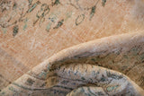 Textured, distressed vintage Oushak carpet pile showing faded beige and mint green.