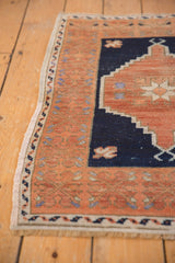 Vintage distressed Oushak border, with copper and navy stepped contour, blue blossoms.