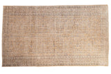 Vintage distressed Oushak carpet, pale gold field, allover faded blue and brown vinery pattern.