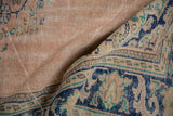 Distressed Oushak carpet reverse and folded pile, showing foundation, dusty rose, cobalt blue.