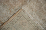 Distressed pile, woven foundation, and intact selvage on a vintage Oushak rug corner.