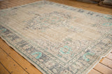 Decorative corner of vintage distressed Oushak rug, highlighting aqua mint and charcoal spandrels.