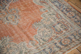 Distressed vintage Oushak rug detail, showing wear, burnt orange, and dusty blue serrated leaves.