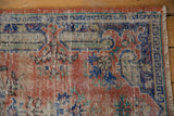 Distressed Oushak rug detail with worn pile, knot heads, madder red, cobalt blue.
