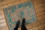 Distressed vintage Oushak rug, worn texture, bright emerald geometric prayer design.