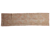 Vintage distressed Oushak rug runner with ivory, beige, pink elongated diamond medallions, 2'3