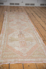 Distressed pile texture and intact side selvage of the vintage Oushak runner.