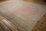 Distressed vintage Turkish Oushak rug with faded pink and ivory abrashed field.