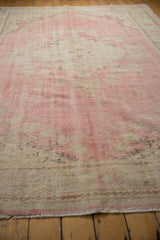 Mostly even wear across distressed Oushak hand knotted pile in faded pink, ivory.