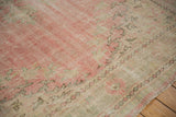 Vintage Distressed Oushak carpet detail showing worn pile, faint foundation, pink, ivory, seafoam.