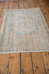 Faded pale beige Oushak rug pile, showing wear to foundation and seafoam tones.