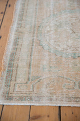 Vintage Distressed Oushak rug edge with visible foundation wear, pale beige, seafoam, apricot.