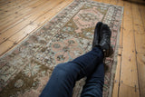 Vintage Distressed Oushak runner with geometric medallions, dusty rose, sage, and worn pile.