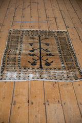 Distressed corner of vintage Oushak rug, showing abrashed field and geometric border detail.