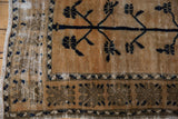 Distressed Oushak corner, deep navy tree-of-life, wide geometric border, and aged texture.