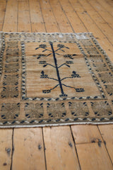 Distressed vintage Oushak rug, abrashed field, simplistic tree of life motif, beige and navy tones.