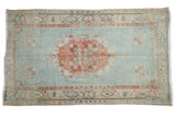 Distressed vintage Turkish Oushak rug, pale cherry red rose medallion, abrashed powder blue field.