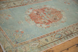 Faded rose motif on abrashed powder blue field of a distressed vintage Oushak rug.