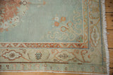 Abrashed powder blue field and ivory border with worn floral patterns on distressed Oushak rug.