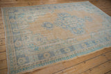 Distressed Oushak rug border with pale saffron, mint green, blue worn patterns.
