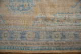 Vintage Distressed Oushak carpet detail: pale saffron, pale denim blue border, and worn pile.