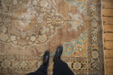 Distressed vintage Oushak rug with faded copper, turquoise, and brown tones, low pile.