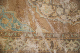 Distressed pile and foundation of vintage Oushak rug in copper, brown, and turquoise.