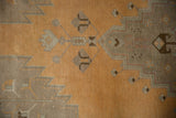 Distressed ochre and silver-grey zig-zag spandrels on this vintage Oushak.