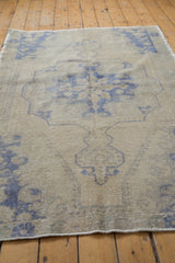 Textured distressed pile of vintage Oushak rug, pale royal blue motifs, and faint foundation.