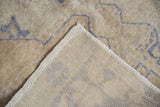 Vintage Oushak rug's distressed pile with faint foundation and tightly woven selvage.